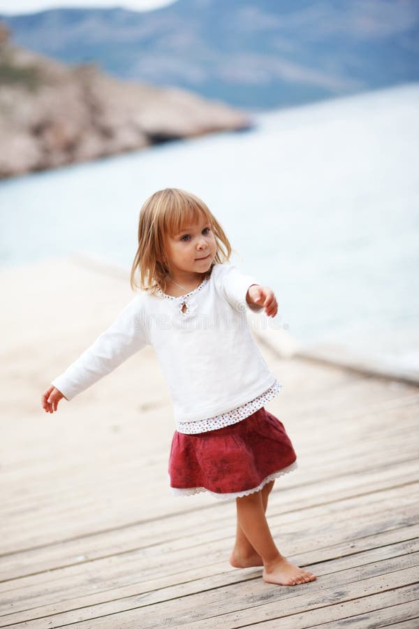 Happy child near sea on berth. Happy child near sea on berth