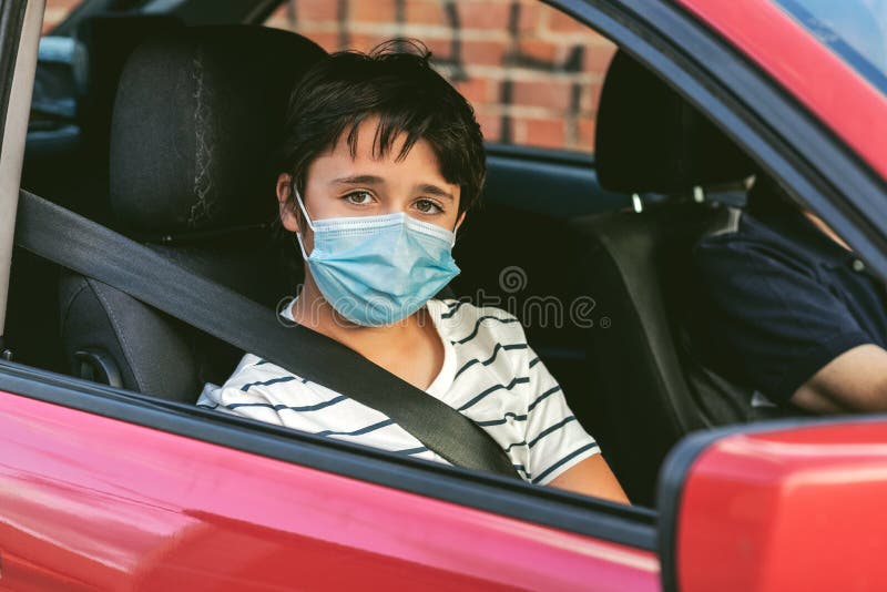 Dziecko z maską chirurgiczną w samochodzie obraz stock