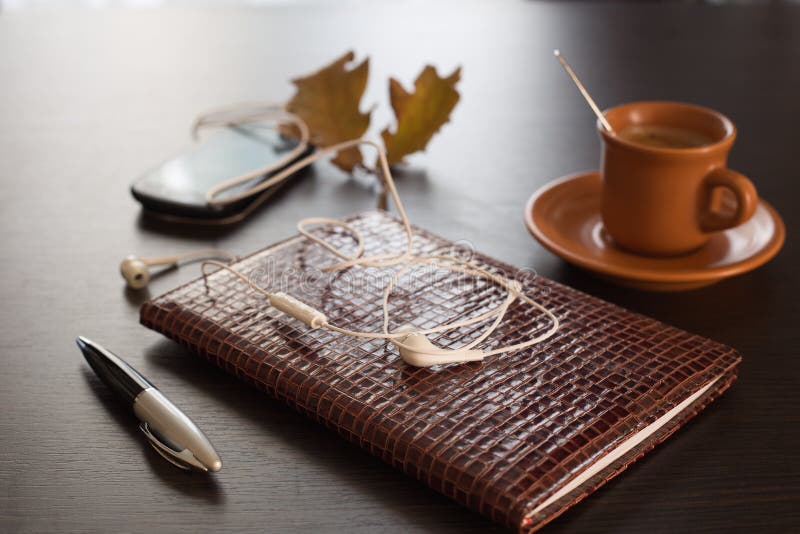 Autumn concept with diary, mobile phone and coffee. Autumn concept with diary, mobile phone and coffee