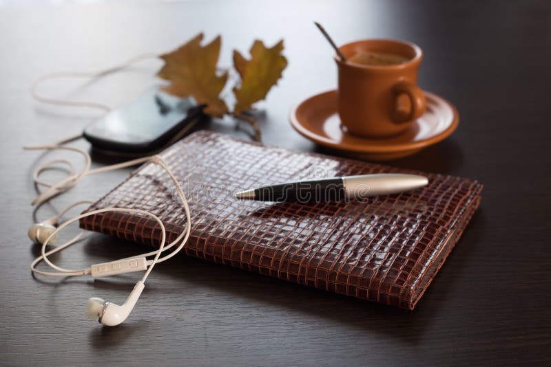 Autumn concept with diary, mobile phone and coffee. Autumn concept with diary, mobile phone and coffee