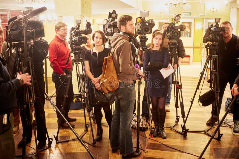 MOSCOW, RUSSIA - JAN 15, 2015: Journalists and cameramen stand in foyer before interviews after media preview of Boris Godunov directed by Peter Stein at Moscow theatre Et Cetera. MOSCOW, RUSSIA - JAN 15, 2015: Journalists and cameramen stand in foyer before interviews after media preview of Boris Godunov directed by Peter Stein at Moscow theatre Et Cetera
