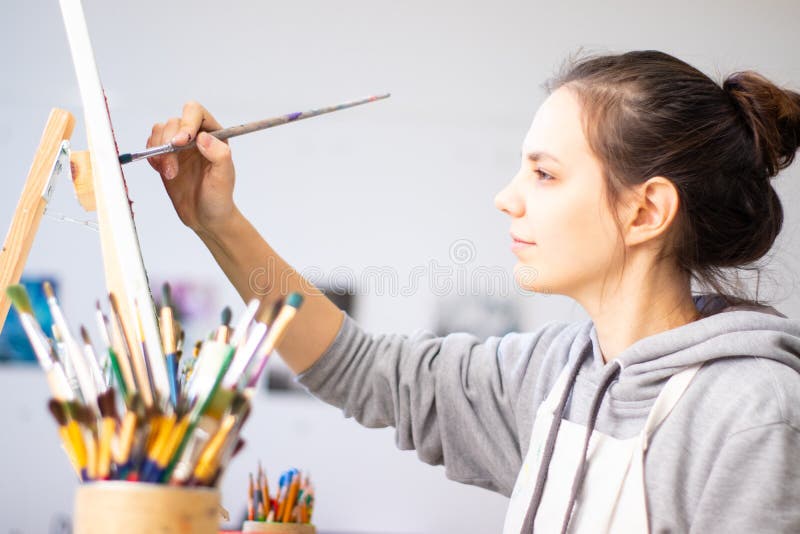 Dziewczyna artysta maluje obrazek na kanwie obraz stock Dziewczyna artysta maluje obrazek na kanwie obraz stock
