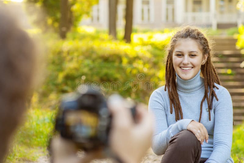 Girl photographer shoot model in summer park. Girl photographer shoot model in summer park