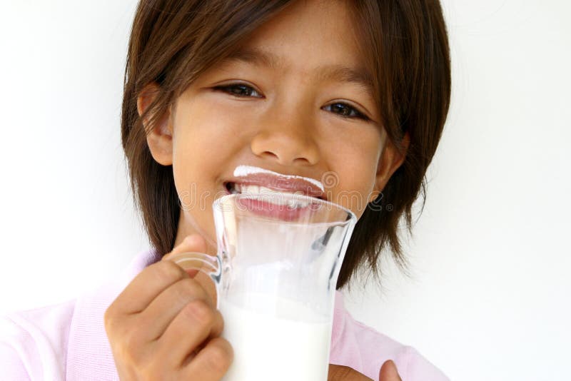 Happy nine year old girl wearing milk moustache after drinking a glass of milk. enough copy space. Fit for milk, health, growing, nutrition, happy child, etc, layout. Happy nine year old girl wearing milk moustache after drinking a glass of milk. enough copy space. Fit for milk, health, growing, nutrition, happy child, etc, layout.