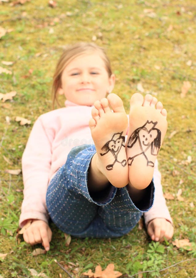 Girl with drawen hearts on soles of bare feet. Girl with drawen hearts on soles of bare feet