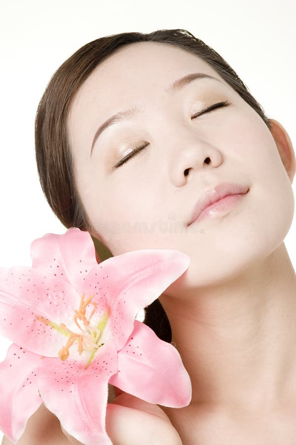 An Asian girl with beautiful skin, taken in studio, for skin protection, beauty saloon, cosmetics advertisement use. An Asian girl with beautiful skin, taken in studio, for skin protection, beauty saloon, cosmetics advertisement use.