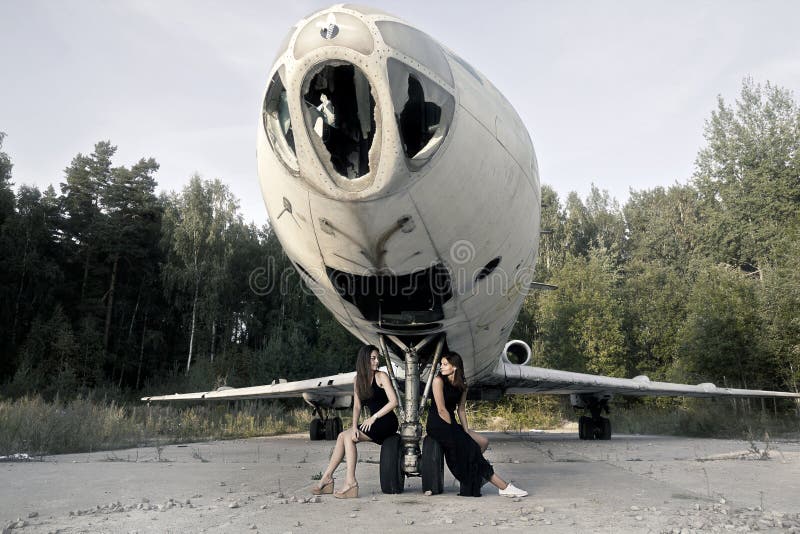 Girls next to the ruined airplane. Girls next to the ruined airplane
