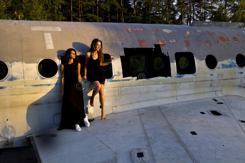 Girls next to the ruined airplane. Girls next to the ruined airplane