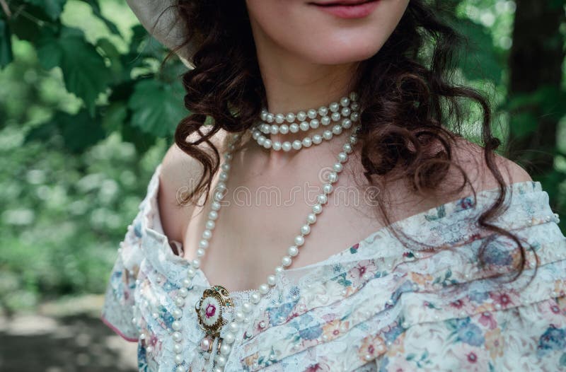 Girl bride in vintage dress, pearls, brooch and hat smiling. Girl bride in vintage dress, pearls, brooch and hat smiling