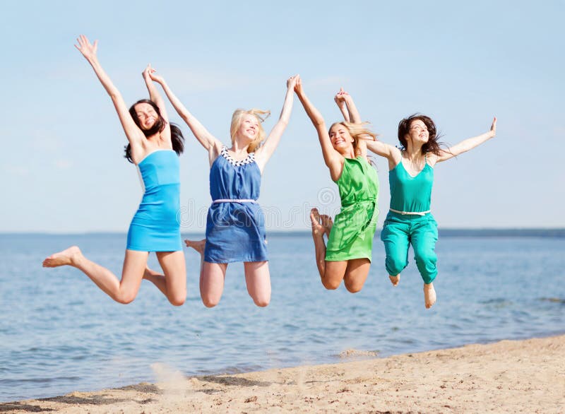 Summer holidays and vacation - girls jumping on the beach. Summer holidays and vacation - girls jumping on the beach