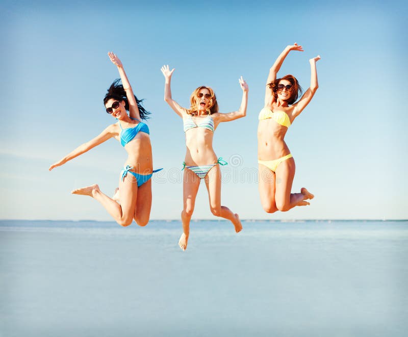 Summer holidays and vacation - girls jumping on the beach. Summer holidays and vacation - girls jumping on the beach.
