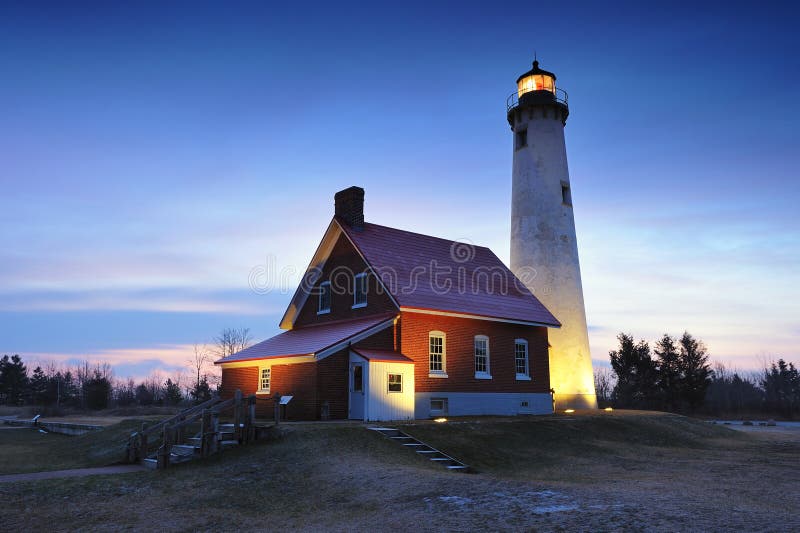 Twilight at Tawas Point Lighthouse, East Tawas, Michigan USA. Just a dusting of snow on this frosty winter predawn scene. Twilight at Tawas Point Lighthouse, East Tawas, Michigan USA. Just a dusting of snow on this frosty winter predawn scene.