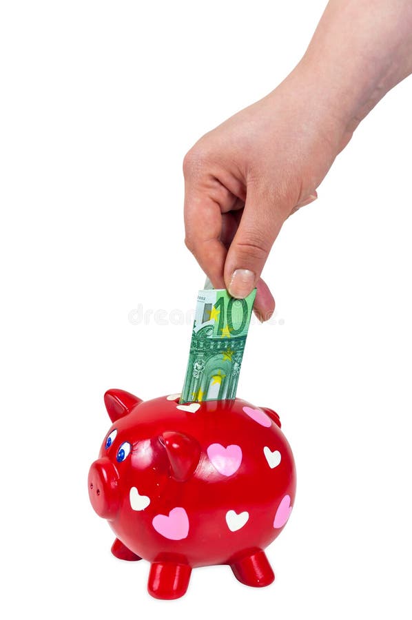 Dé la inserción de la moneda en la hucha fotografía de archivo libre de regalías Dé la inserción de la moneda en la hucha fotografía de archivo libre de regalías