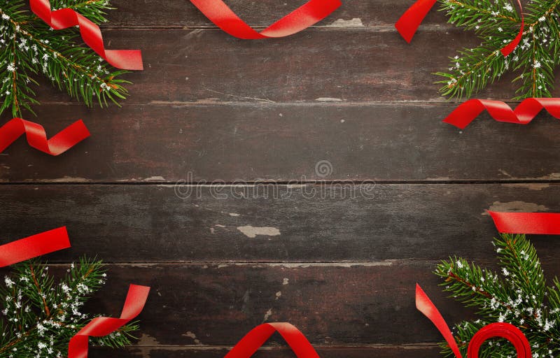 Christmas decorations on wooden table. Top view of table with christmas tree and decorative strips. Free space for text. Christmas decorations on wooden table. Top view of table with christmas tree and decorative strips. Free space for text.