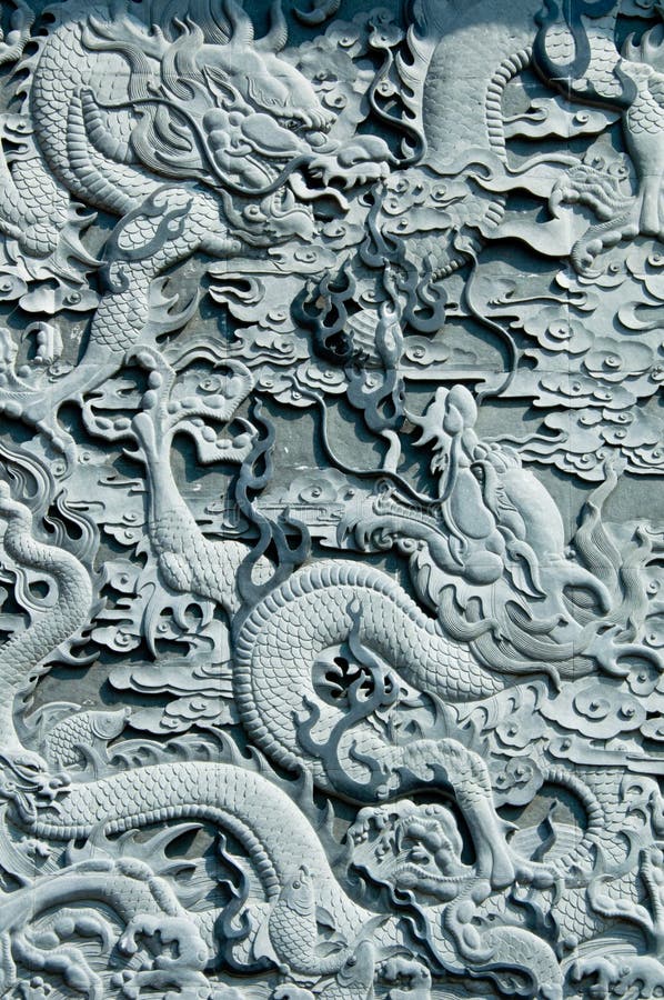 A stone carving with ancient Asian dragon theme. A stone carving with ancient Asian dragon theme