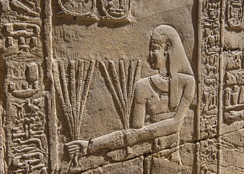 Découpages hiéroglyphiques sur un mur égyptien antique de temple photo libre de droits Découpages hiéroglyphiques sur un mur égyptien antique de temple photo libre de droits