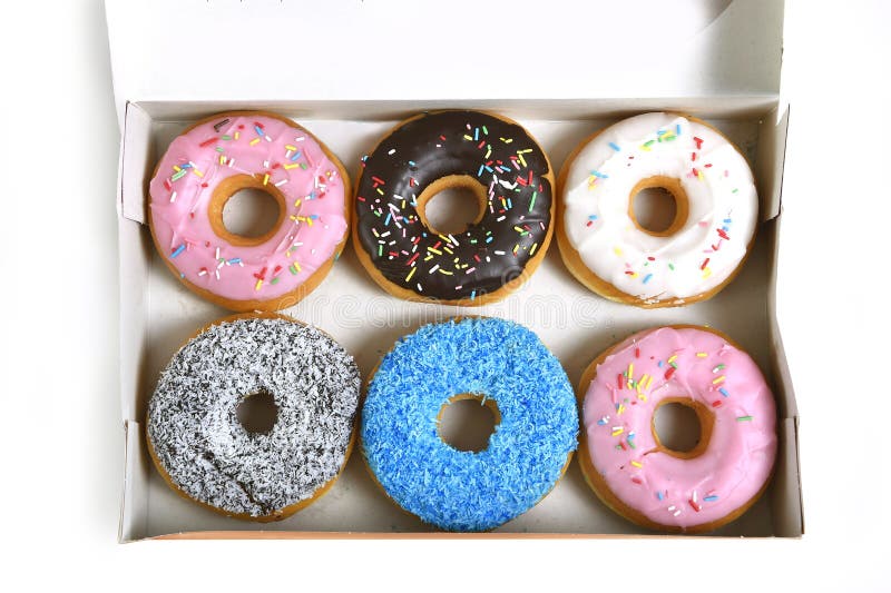 Delicious and tempting box full of donuts with different flavors and toppings in unhealthy nutrition and sugar and sweet cake addiction concept. Delicious and tempting box full of donuts with different flavors and toppings in unhealthy nutrition and sugar and sweet cake addiction concept