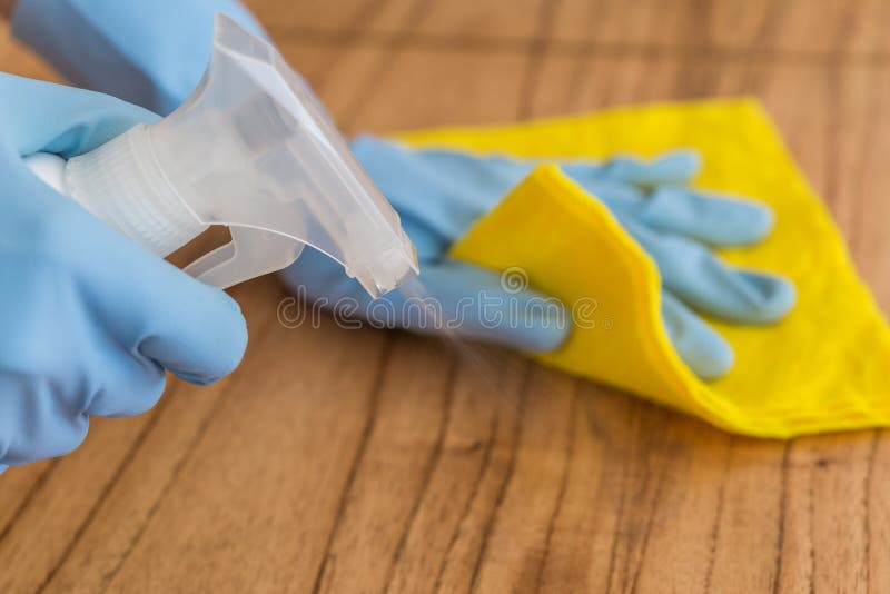 Disinfecting a table surface with rubbing alcohol for prevention of coronavirus. Disinfecting a table surface with rubbing alcohol for prevention of coronavirus