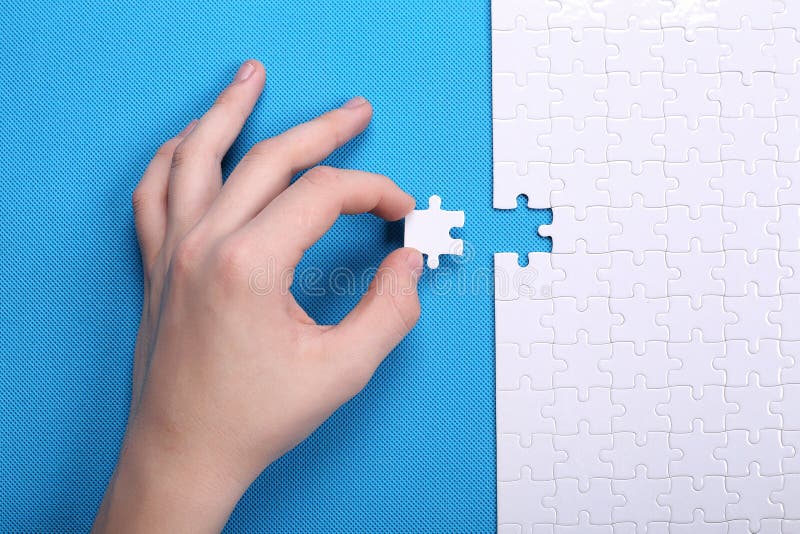 Détails blancs d'un puzzle sur un fond bleu Un puzzle est une unité centrale photos stock Détails blancs d'un puzzle sur un fond bleu Un puzzle est une unité centrale photos stock