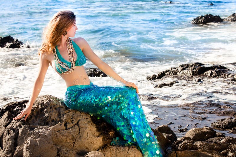 Beautiful Mermaid on Lava Rocks at the Ocean on the Big Island of Hawaii. Beautiful Mermaid on Lava Rocks at the Ocean on the Big Island of Hawaii