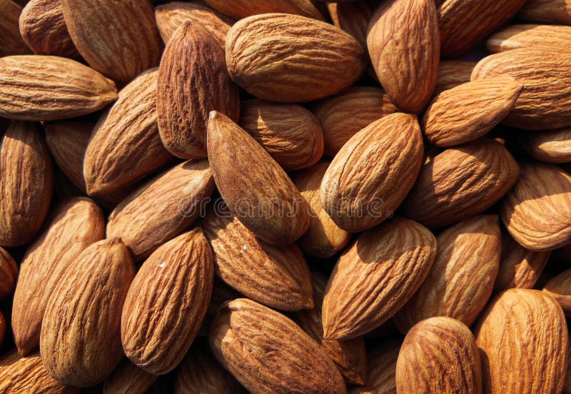 Closeup of Almond nuts heap abstract food product background. Closeup of Almond nuts heap abstract healthy food product background illustration or wallpaper