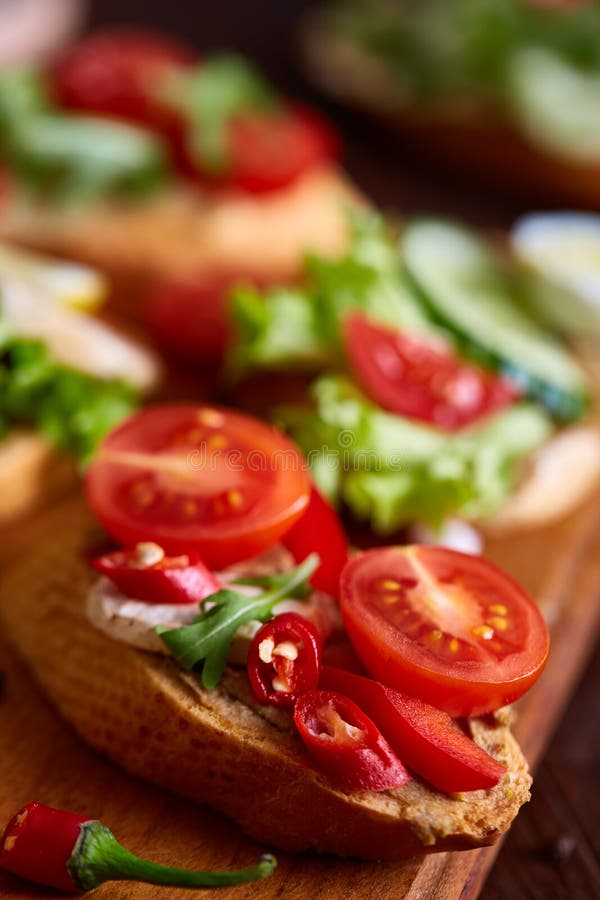 Breakfast sandwich with homemade paste, vegetables and fresh greens, shallow depth of field. E r o äta för begrepp som är sunt