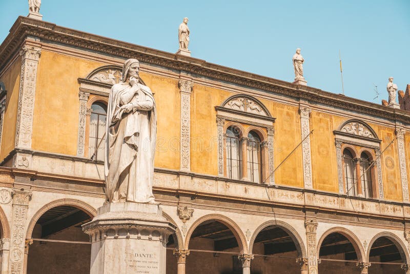 Beautiful statue of Dante in the middle of Verona old town with other sculptures and architecture. Beautiful statue of Dante in the middle of Verona old town with other sculptures and architecture.