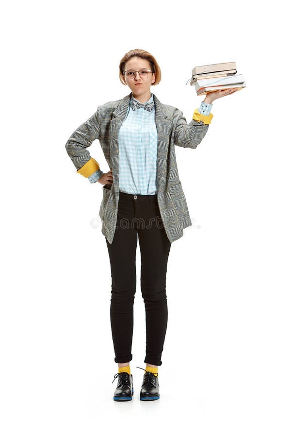 Full length portrait of a happy smiling female student holding books isolated on white background. R E o