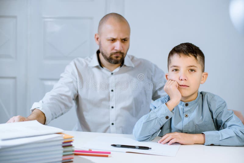 Мальчик за столом и рядом папа. His father looked at him Angry. Мальчик отец учитель