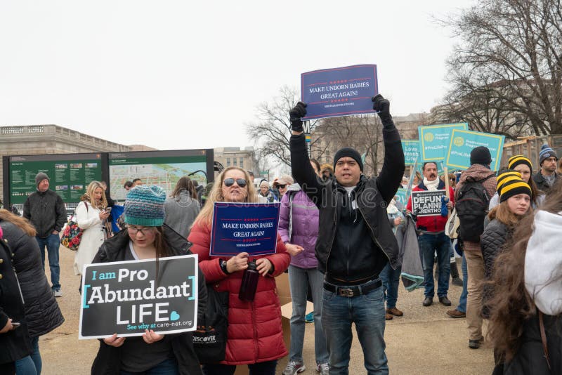 WASHINGTON D.C./USA - JANUARY 18, 2019: Pro-life supporters holding signs gather for the annual March for Life. WASHINGTON D.C./USA - JANUARY 18, 2019: Pro-life supporters holding signs gather for the annual March for Life