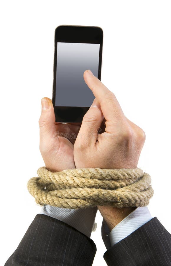 Hands of businessman addicted to mobile phone rope bond wrists in smartphone internet addiction and slave to online network addict concept isolated black background. Hands of businessman addicted to mobile phone rope bond wrists in smartphone internet addiction and slave to online network addict concept isolated black background