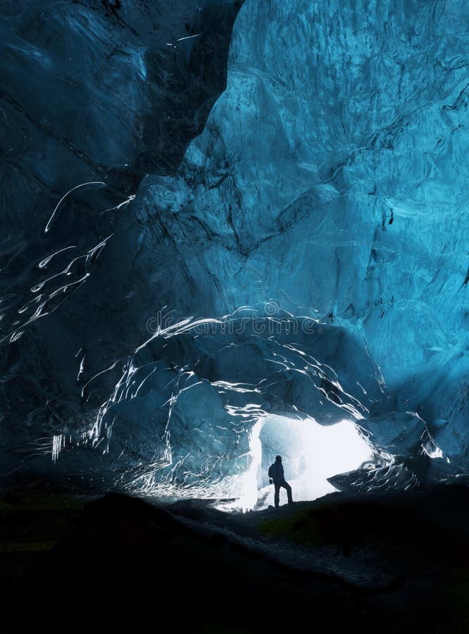 Man exploring an amazing glacial cave in Iceland