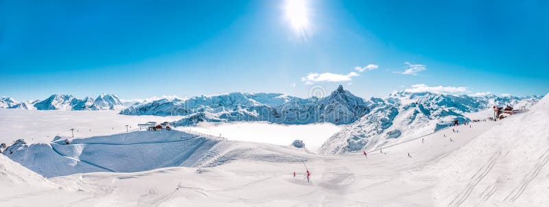 Panorama of Mountain Range winter Landscape with Blue Sky and skiing slopes at Meribel Skiing Resort in French Alps. Panorama of Mountain Range winter Landscape with Blue Sky and skiing slopes at Meribel Skiing Resort in French Alps.