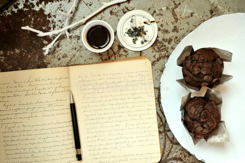 Artist's morning with notebook , coffee and cigarettes on a vintage background . Inspiration concept image , writer's desk . Artist's morning with notebook , coffee and cigarettes on a vintage background . Inspiration concept image , writer's desk .