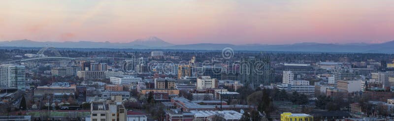 View of Portland Oregon Pearl District Cityscape with Mt St Helens and Mt Adams Fremont Bridge during Sunset Panorama. View of Portland Oregon Pearl District Cityscape with Mt St Helens and Mt Adams Fremont Bridge during Sunset Panorama