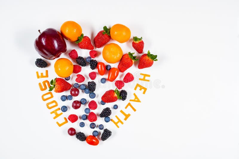 Heart shaped fruit arrangement with Choose Health message in it made out of tangerine peels in a clean white background with copy space. Heart shaped fruit arrangement with Choose Health message in it made out of tangerine peels in a clean white background with copy space