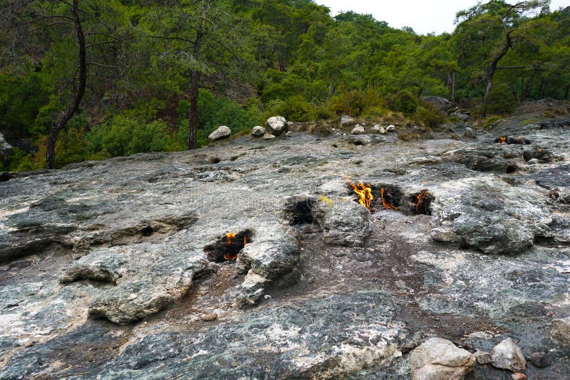 Cirali, Antalya/Turkey-January 01, 2018: Chimera, burning rocks are remarkable spot ot the trail of Lycian way near Cirali, Antalya. Cirali, Antalya/Turkey-January 01, 2018: Chimera, burning rocks are remarkable spot ot the trail of Lycian way near Cirali, Antalya