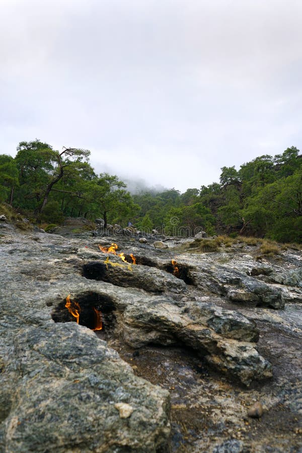 Cirali, Antalya/Turkey-January 01, 2018: Chimera, burning rocks are remarkable spot ot the trail of Lycian way near Cirali, Antalya. Cirali, Antalya/Turkey-January 01, 2018: Chimera, burning rocks are remarkable spot ot the trail of Lycian way near Cirali, Antalya