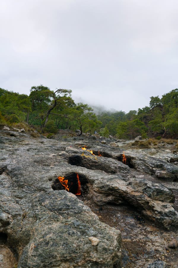 Cirali, Antalya/Turkey-January 01, 2018: Chimera, burning rocks are remarkable spot ot the trail of Lycian way near Cirali, Antalya. Cirali, Antalya/Turkey-January 01, 2018: Chimera, burning rocks are remarkable spot ot the trail of Lycian way near Cirali, Antalya