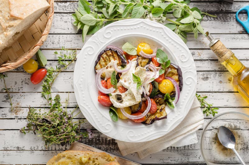 Grilled eggplant with tomatoes. Fresh vegetable grilled with herbs and spicy, topped with flavored mozzarella cheese and crispy crumb