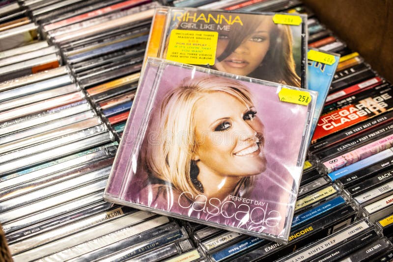 Nadarzyn, Poland, May 11, 2019: Cascada CD album Perfect Day 2007 on display for sale, famous German dance music band, collection of CD music albums in background. Nadarzyn, Poland, May 11, 2019: Cascada CD album Perfect Day 2007 on display for sale, famous German dance music band, collection of CD music albums in background