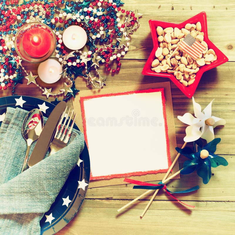 Fourth of July Rustic Table Place Setting in Red, White and Blue Colors with Menu or Invite Card with Copy Space.  A Square crop vintage, cross processed tones. Fourth of July Rustic Table Place Setting in Red, White and Blue Colors with Menu or Invite Card with Copy Space.  A Square crop vintage, cross processed tones