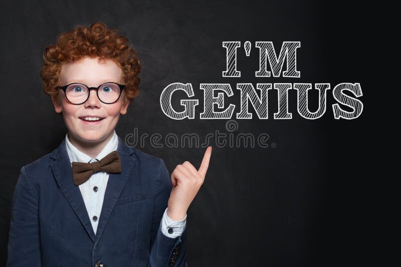 Happy redhead child in glasses and suit on black background.