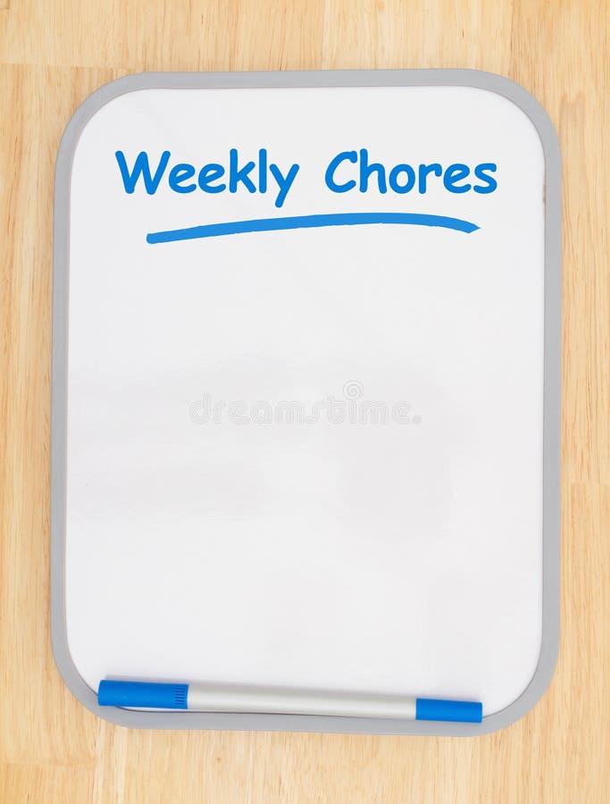 Weekly chores list on white dry erase board with marker on wood textured wall with copy space for your message