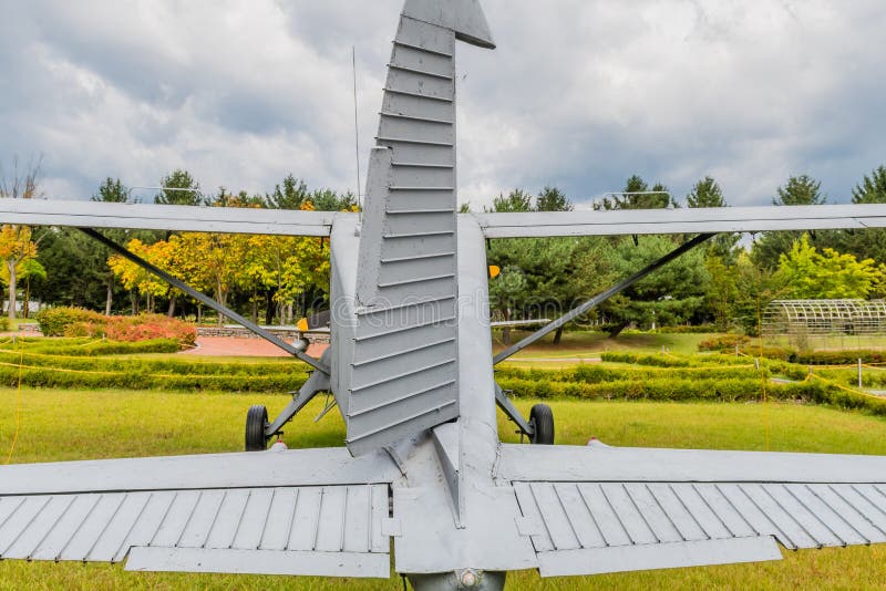 Rear view of De Havilland U-6 military training aircraft on display in public park. Rear view of De Havilland U-6 military training aircraft on display in public park