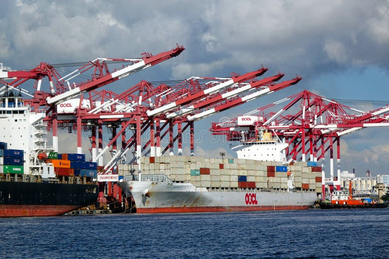 KAOHSIUNG, TAIWAN -- JUNE 2, 2019: Containers are being loaded onto ships in Kaohsiung Port. KAOHSIUNG, TAIWAN -- JUNE 2, 2019: Containers are being loaded onto ships in Kaohsiung Port