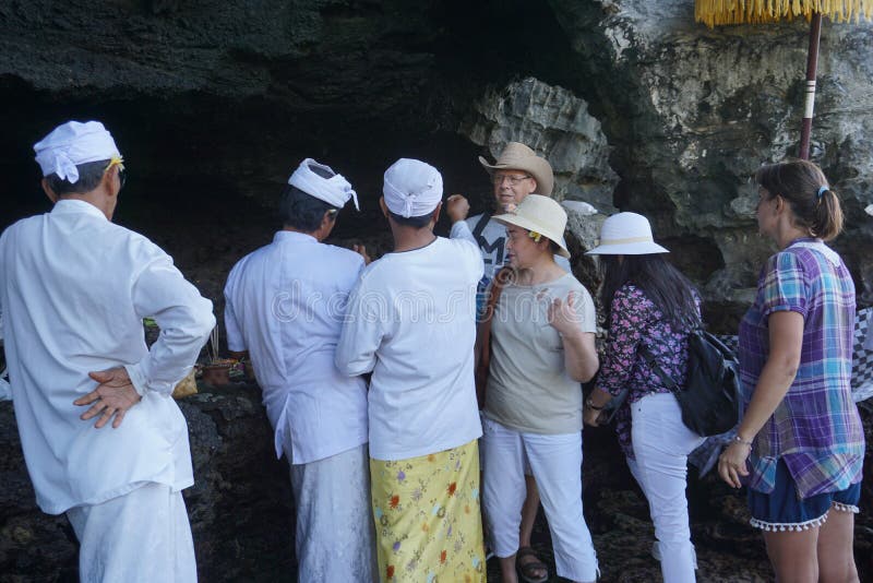Tabanan Pura Tanah Lot Hindischer Tempel errichtet auf einer kleinen Insel Ein Tourist wird von einem hindischen Priester, Indone stockbild Tabanan Pura Tanah Lot Hindischer Tempel errichtet auf einer kleinen Insel Ein Tourist wird von einem hindischen Priester, Indone stockbild