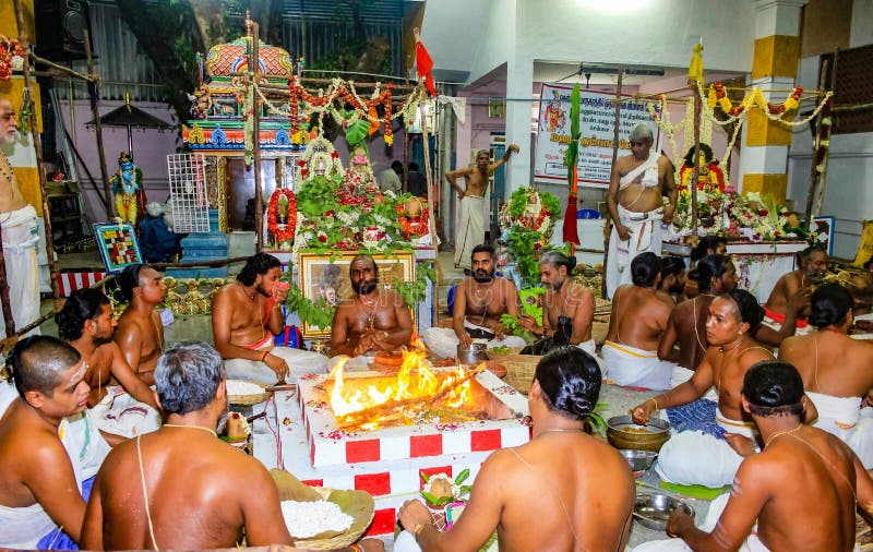 Hindu priests perform a sacred ritual, or yagna, sitting around a fire and pouring ghee into the flames, while chanting prayers, or mantras. These rituals are performed on auspicious occasions, with specific objectives in mind, for the welfare of all humanity. 
Picture taken on July 02, 2012, around 07.30 PM, with a Canon DSLR EOS 550D, focal length 18 mm, aperture f /4, shutter speed 1/60 sec., using flash.