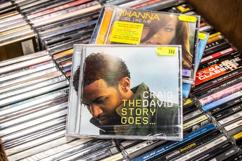 Nadarzyn, Poland, May 11, 2019: Craig David CD album The Story Goes... 2005 on display for sale, famous English singer, songwriter, rapper, collection of CD music albums in background. Nadarzyn, Poland, May 11, 2019: Craig David CD album The Story Goes... 2005 on display for sale, famous English singer, songwriter, rapper, collection of CD music albums in background