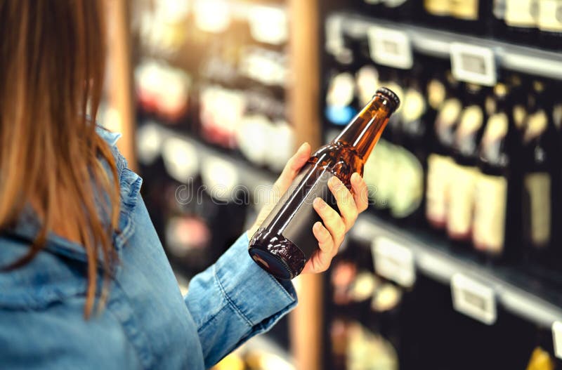 Cliente comprando cerveja em loja de bebidas Cervejas de cerveja ou de trigo IPA ou pálido Mulher na prateleira de álcool imagens de stock Cliente comprando cerveja em loja de bebidas Cervejas de cerveja ou de trigo IPA ou pálido Mulher na prateleira de álcool imagens de stock